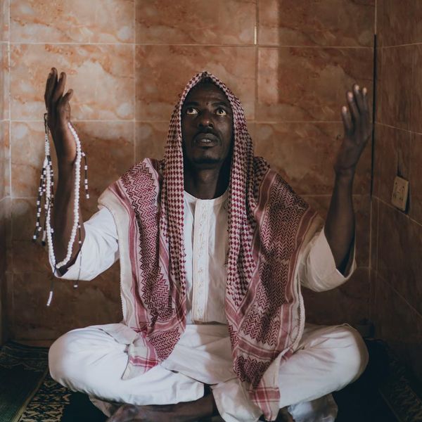 A serene person sitting in a meditation pose, surrounded by a calm atmosphere.